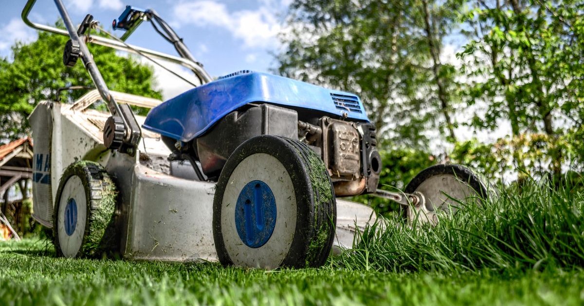 Lawn mower cutting grass on a residential property