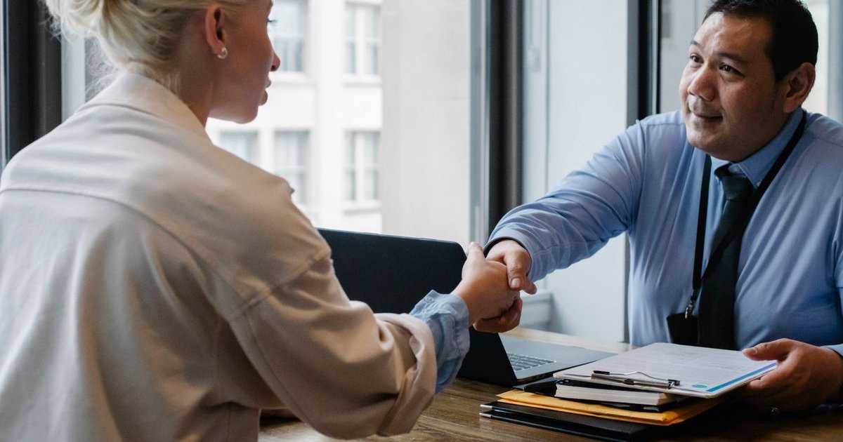 Business owner shaking hands with a satisfied client